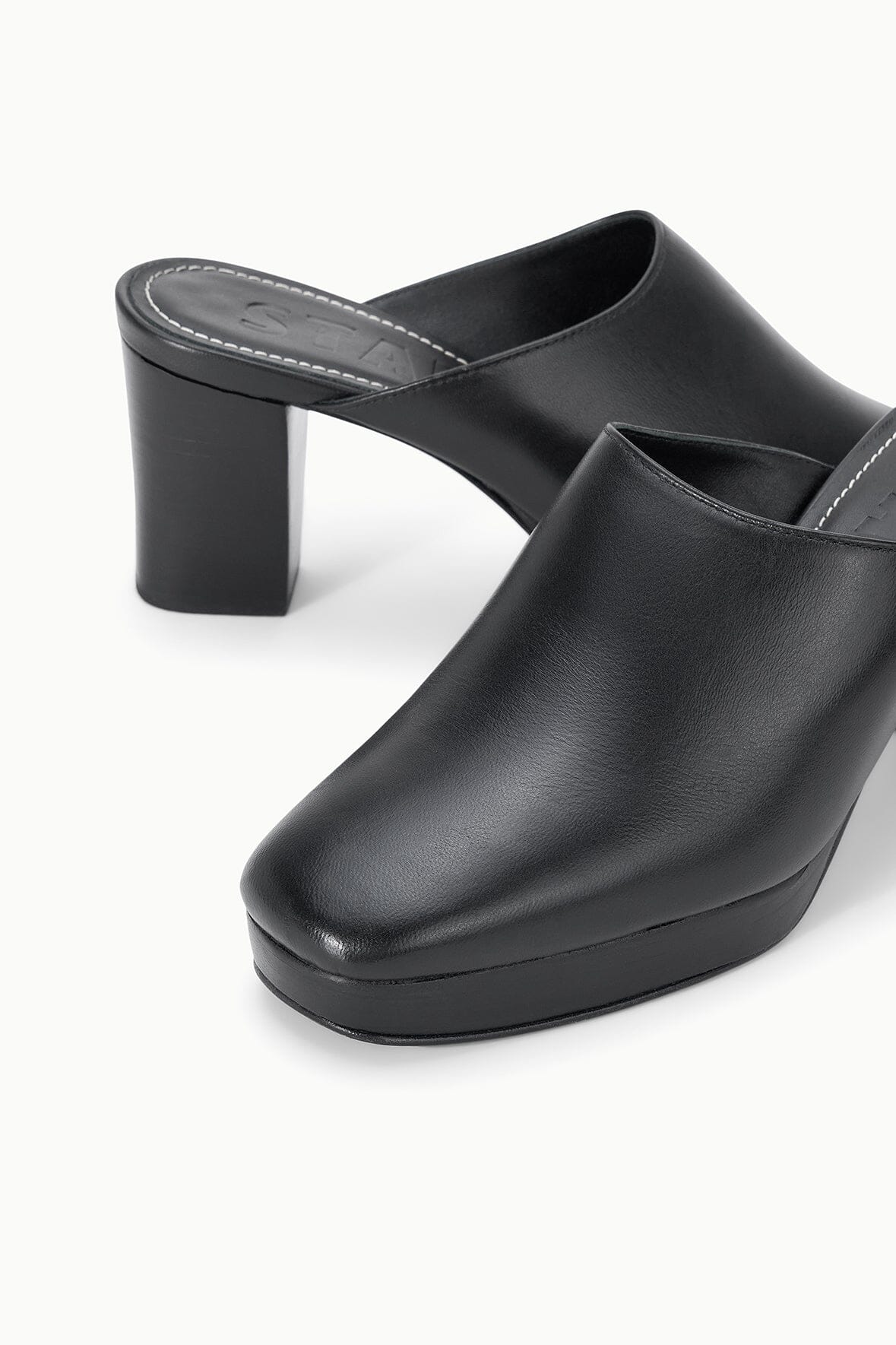 Black leather mule clog close-up with block heel