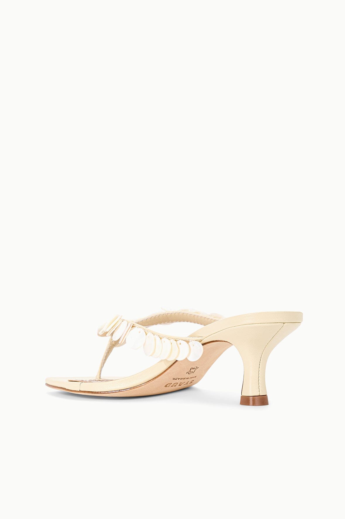Cream kitten-heel slide sandal with white braided strap and scalloped trim