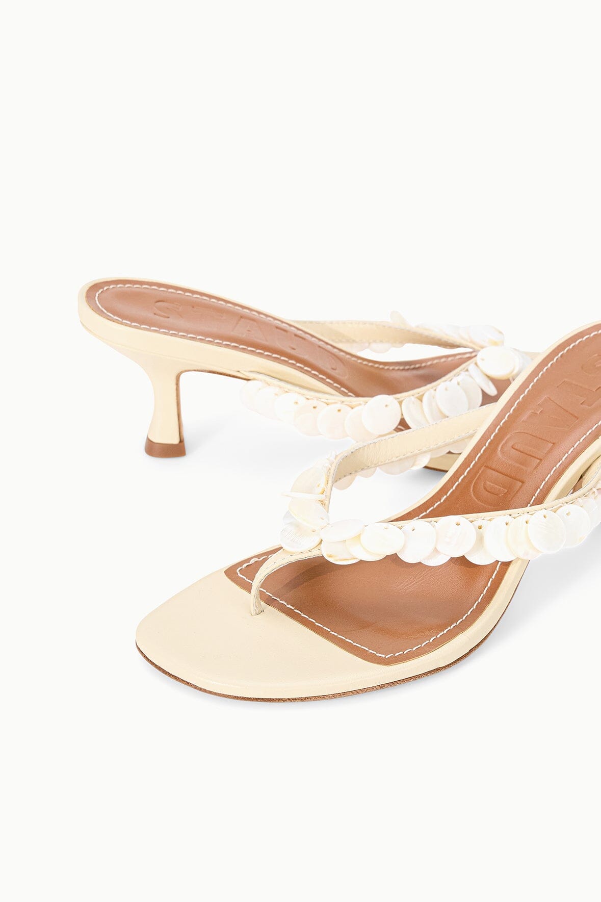 Cream kitten-heel mule sandal with white flower applique strap detail