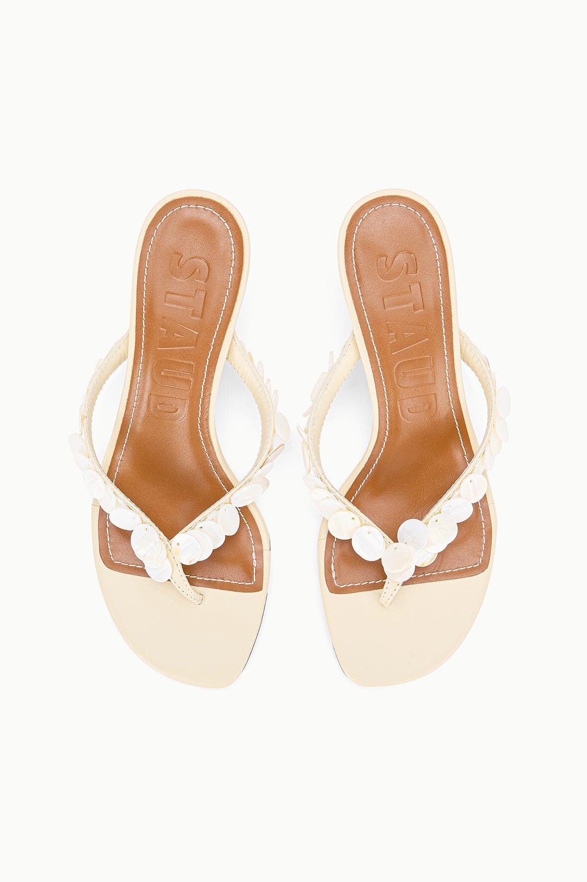 Cream kitten-heel thong sandals with white scalloped strap and logo insole