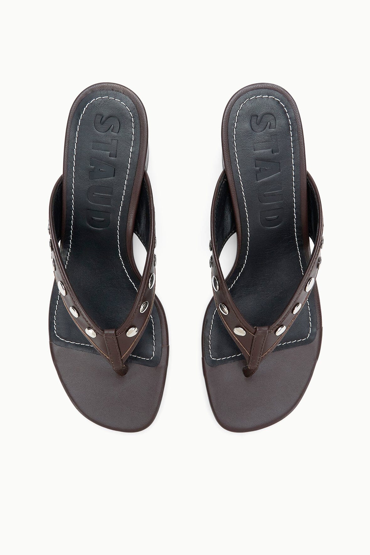 Pair of dark brown thong heel sandals with silver studs and stitched V panel