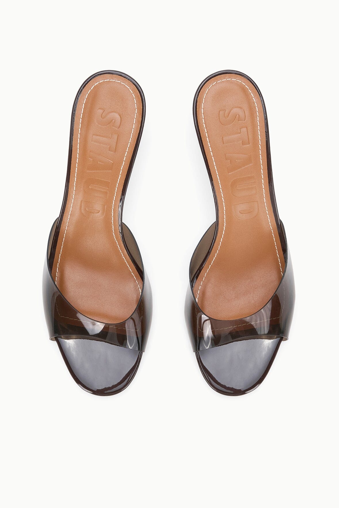 Pair of espresso clear-strap mules with tan lining and mid heel