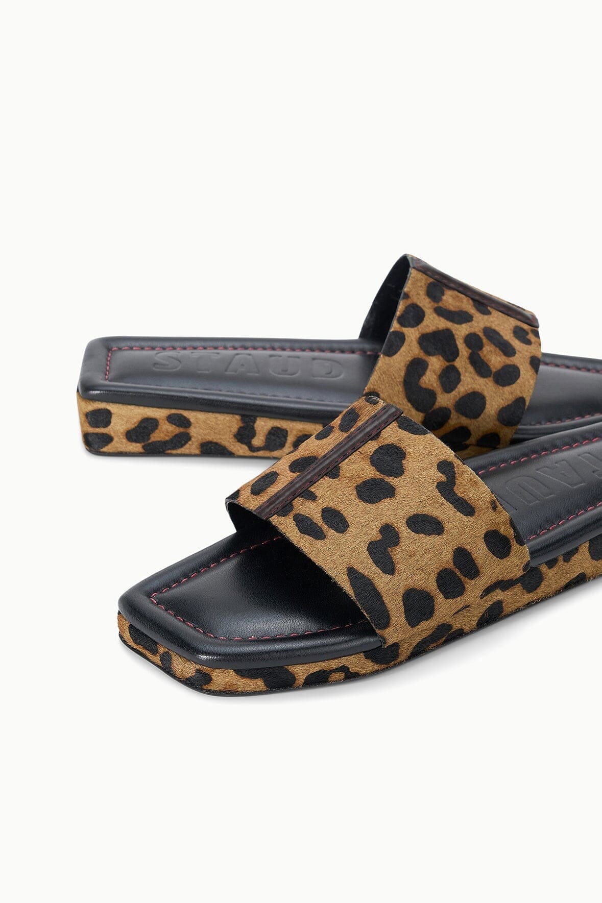 Cheetah-print platform slide sandal with black footbed and stitched edges