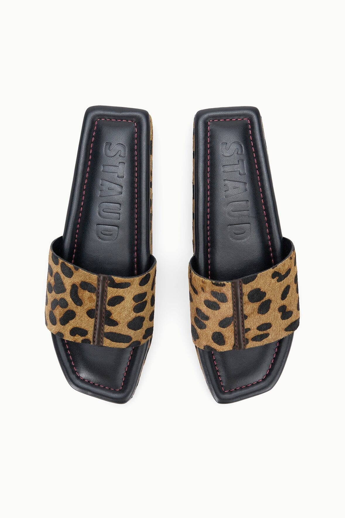 Cheetah-print platform slide sandals with black outsole and red stitched trim