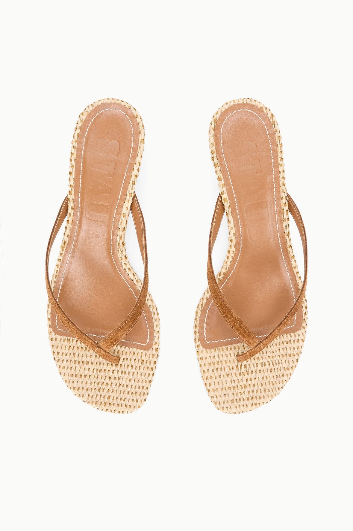 Pair of natural woven kitten-heel thong sandals with tan leather toe straps.