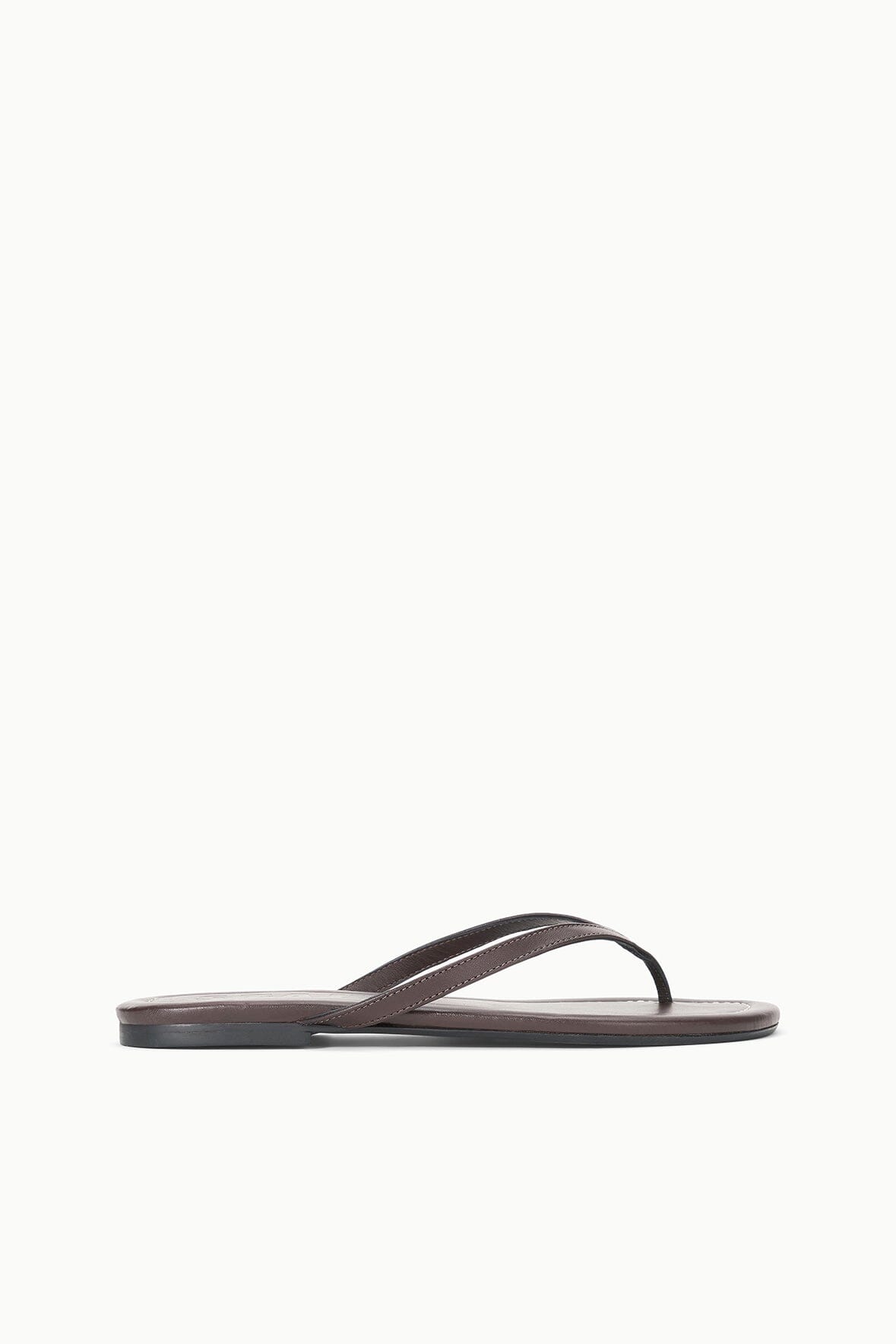 Espresso brown thong sandal in profile with narrow strap and flat outsole