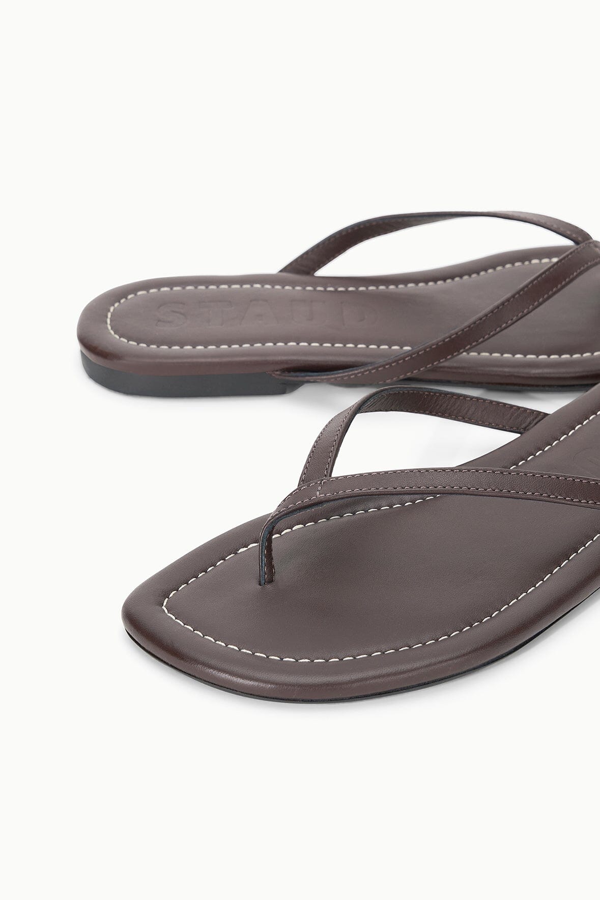 Espresso brown leather thong sandals, close-up of seam stitching and strap