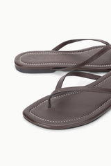 Espresso brown leather thong sandals, close-up of seam stitching and strap