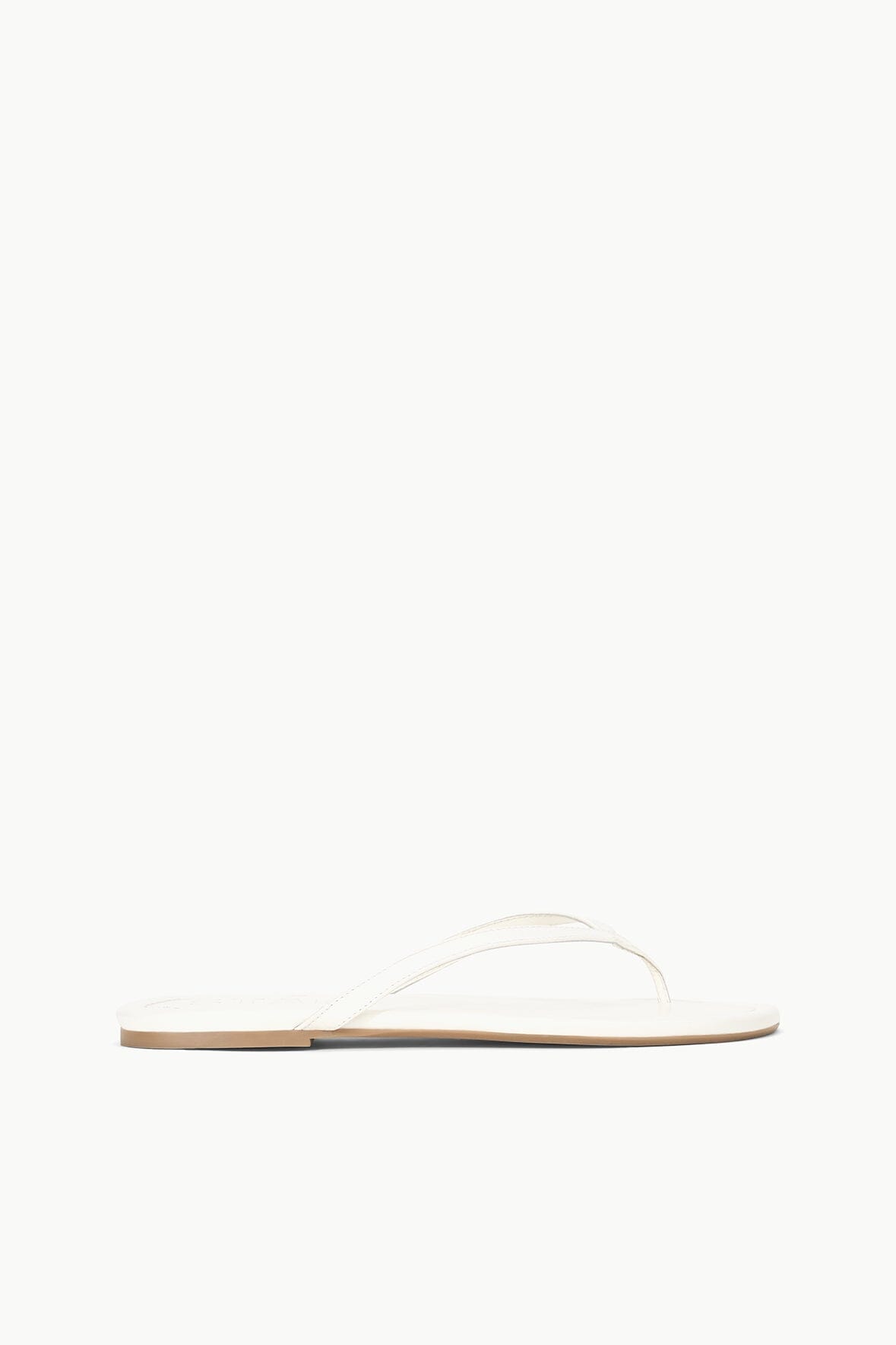 White thong sandal with thin toe strap and flat sole