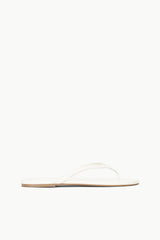 White thong sandal with thin toe strap and flat sole