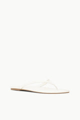 White thong sandal with crisscross straps and flat sole