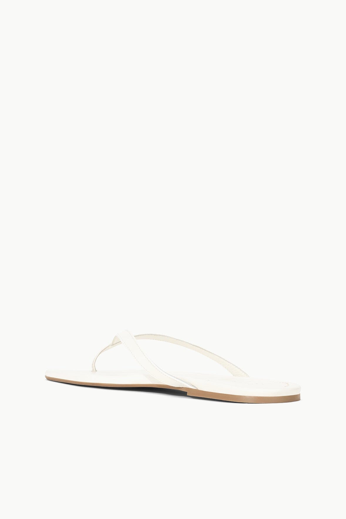 White thong sandal with thin straps and flat sole