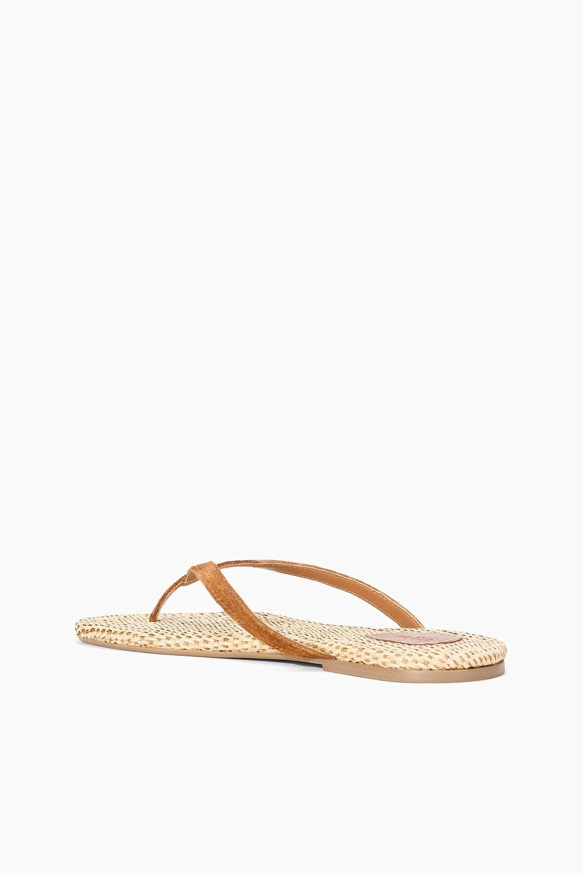 Tan woven flat thong sandals with wide curved toe strap and flat footbed