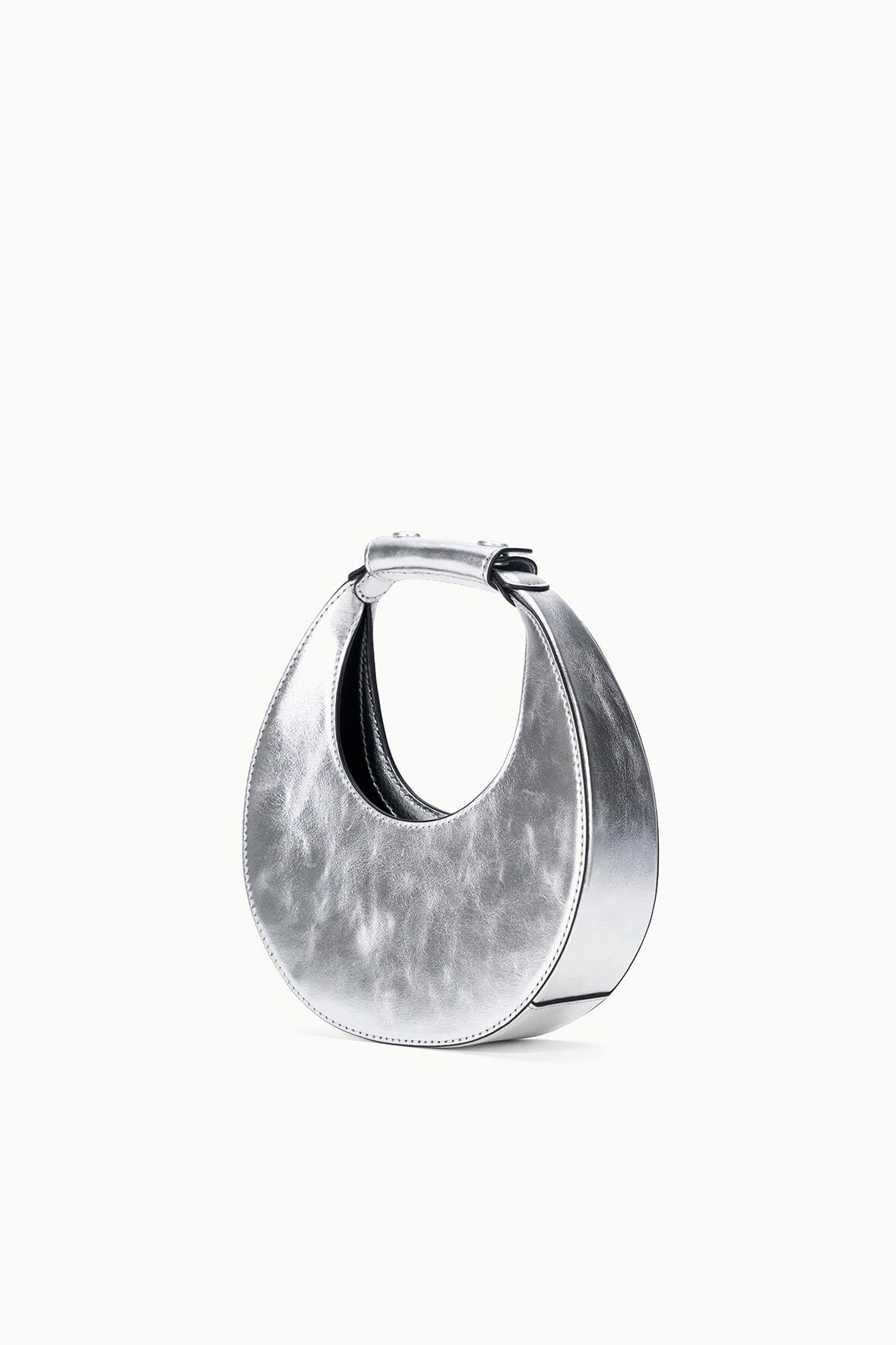 Silver crescent bag with side handle and open top, inner lining visible