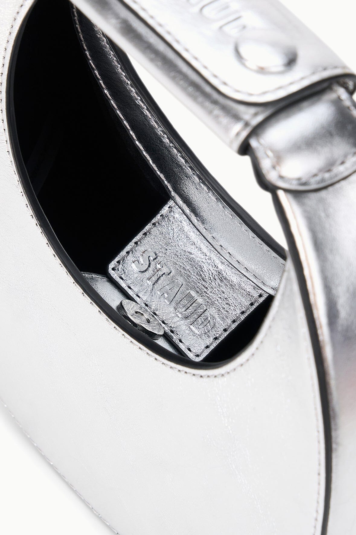 Silver bag interior with stitched card pocket and stamped label
