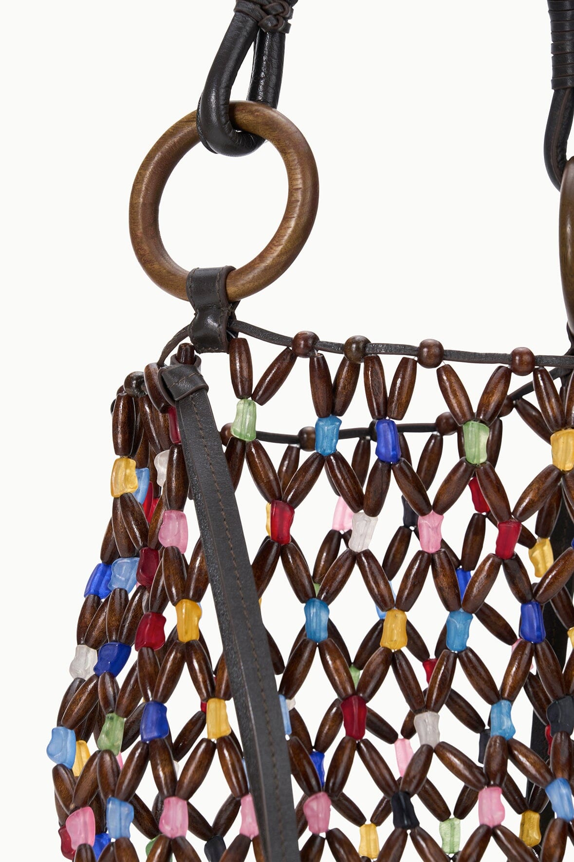 Close-up of Del Mar bucket bag handle with black strap and multicolor beaded lattice trim