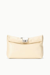 Cream cuff clutch with curved front flap and silver clasp, side shoulder strap.