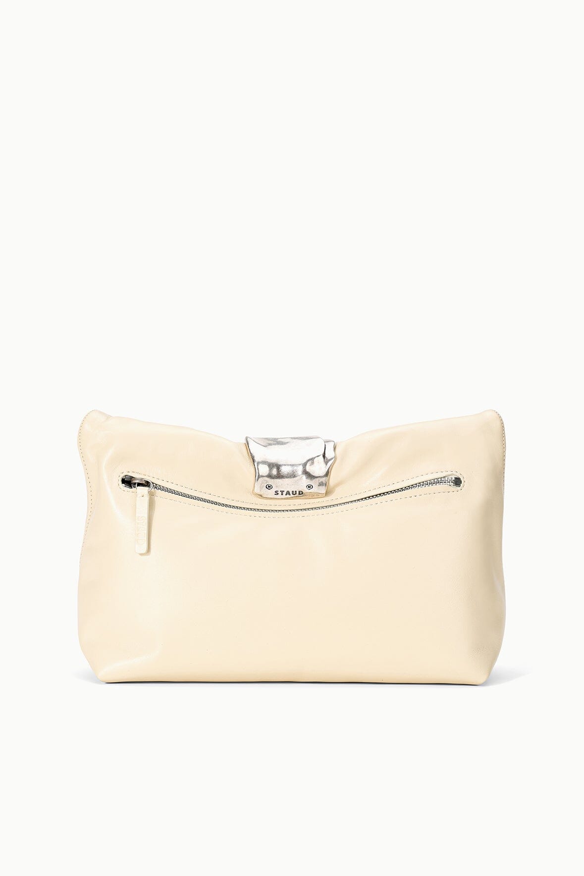 Cream cuff clutch with silver clasp and two zipper pulls on front panel.