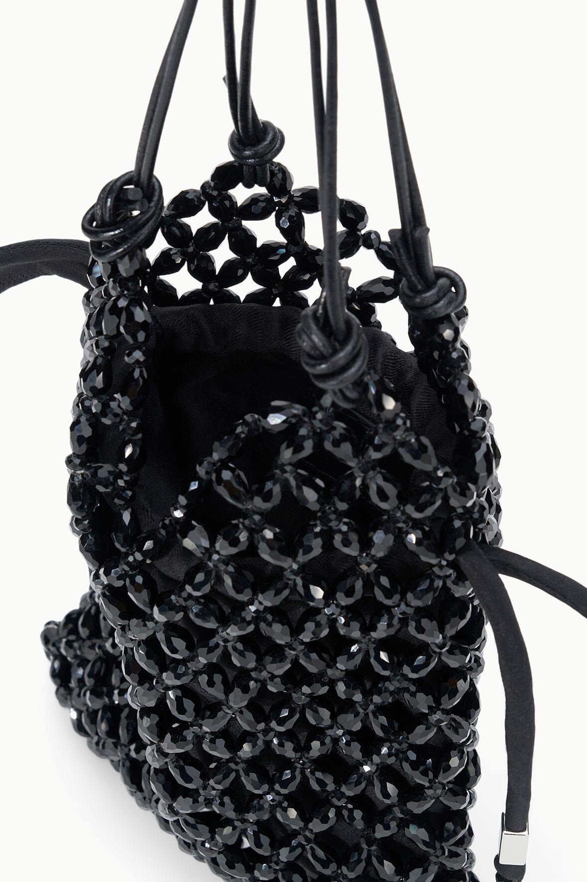 Black beaded tote bag with open top, hanging cords, and knotted handle straps