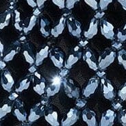 Close-up of dark blue faceted beads with silver sparkle pattern