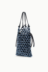 Dark blue beaded bucket bag with curved top straps and hanging drawstring cords