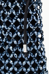 Close-up of dark blue and silver beaded fabric with black strap attachment
