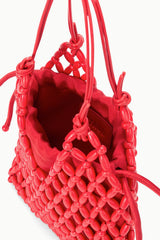 Red beaded bucket bag interior with braided drawstring handles and cord ties