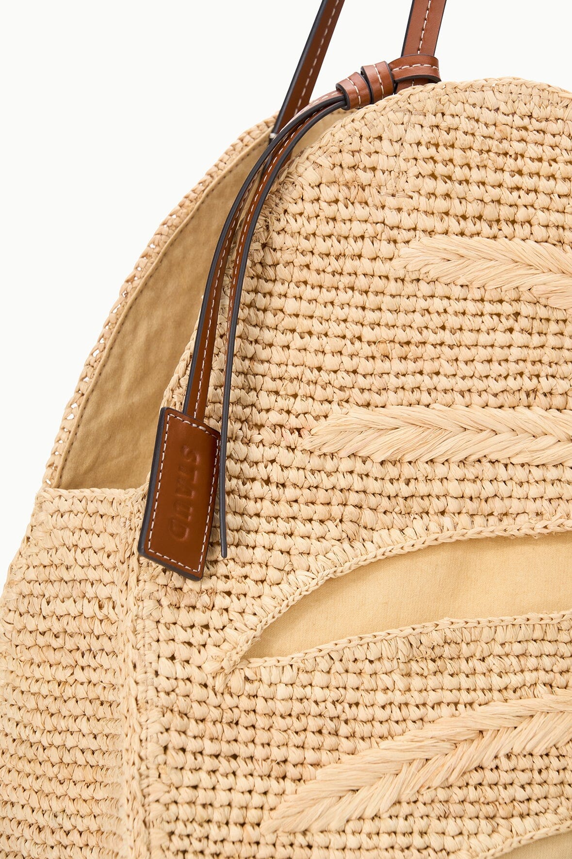 Large natural raffia bag with brown leather straps and woven palm pattern
