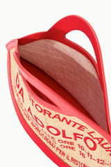 Fish-shaped tote bag interior view with red lining and printed text on beige panel