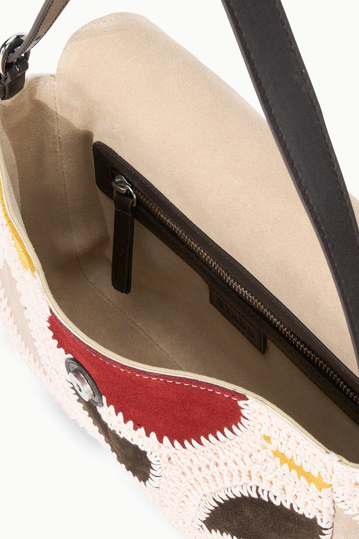 Patchwork suede bag interior with zipper closure and black leather trim
