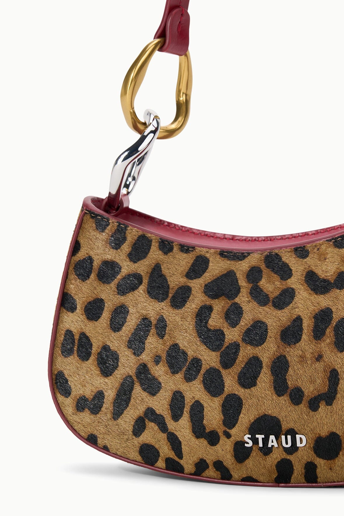 OLLIE bag in cheetah print with burgundy trim and gold ring handle, half-moon shape