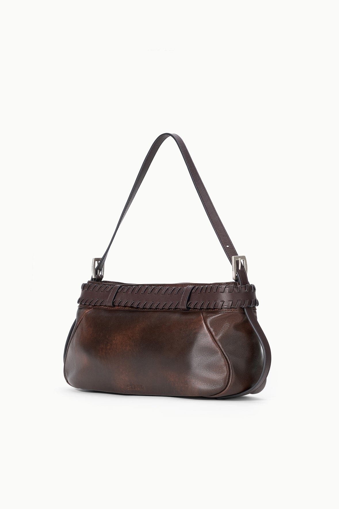 Espresso-brown shoulder bag with top handles and distressed strap panel.