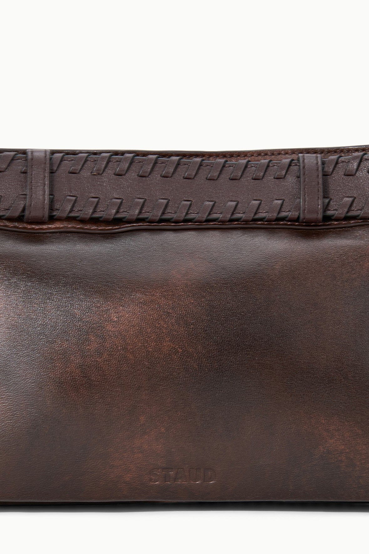 Espresso-brown leather shoulder bag close-up of stitched front band.
