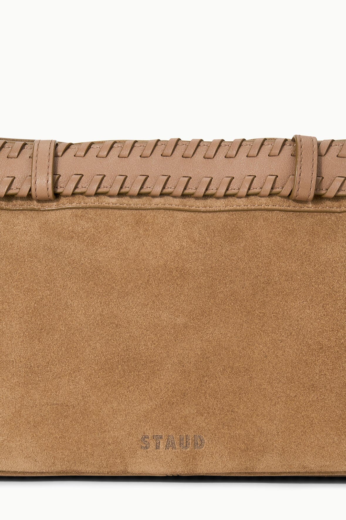 Tan suede shoulder bag front panel with stitched detail and “STAUD” logo