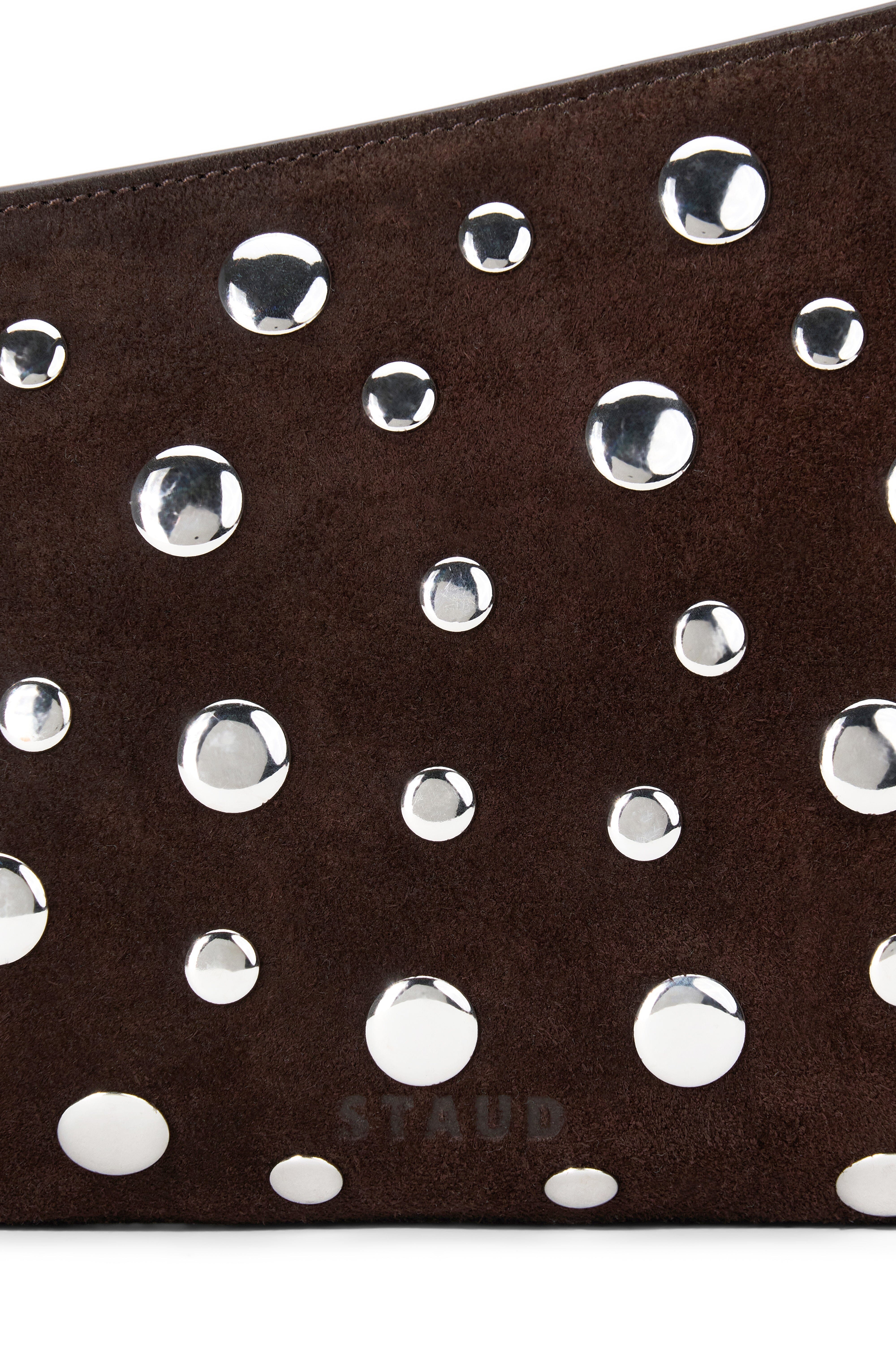 Close-up of dark brown suede mini shoulder bag with scattered silver studs.