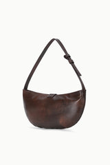 Espresso-brown crescent shoulder bag with curved silhouette and short shoulder strap