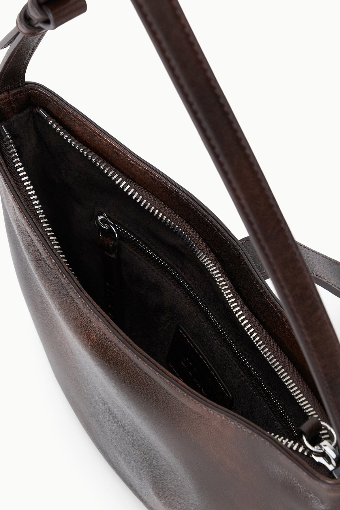 Open Espresso-brown crescent shoulder bag interior with zip pocket and stitching detail