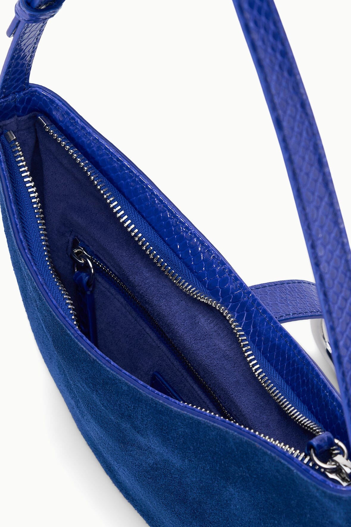 Cobalt crescent shoulder bag interior with zip pocket and blue fabric lining