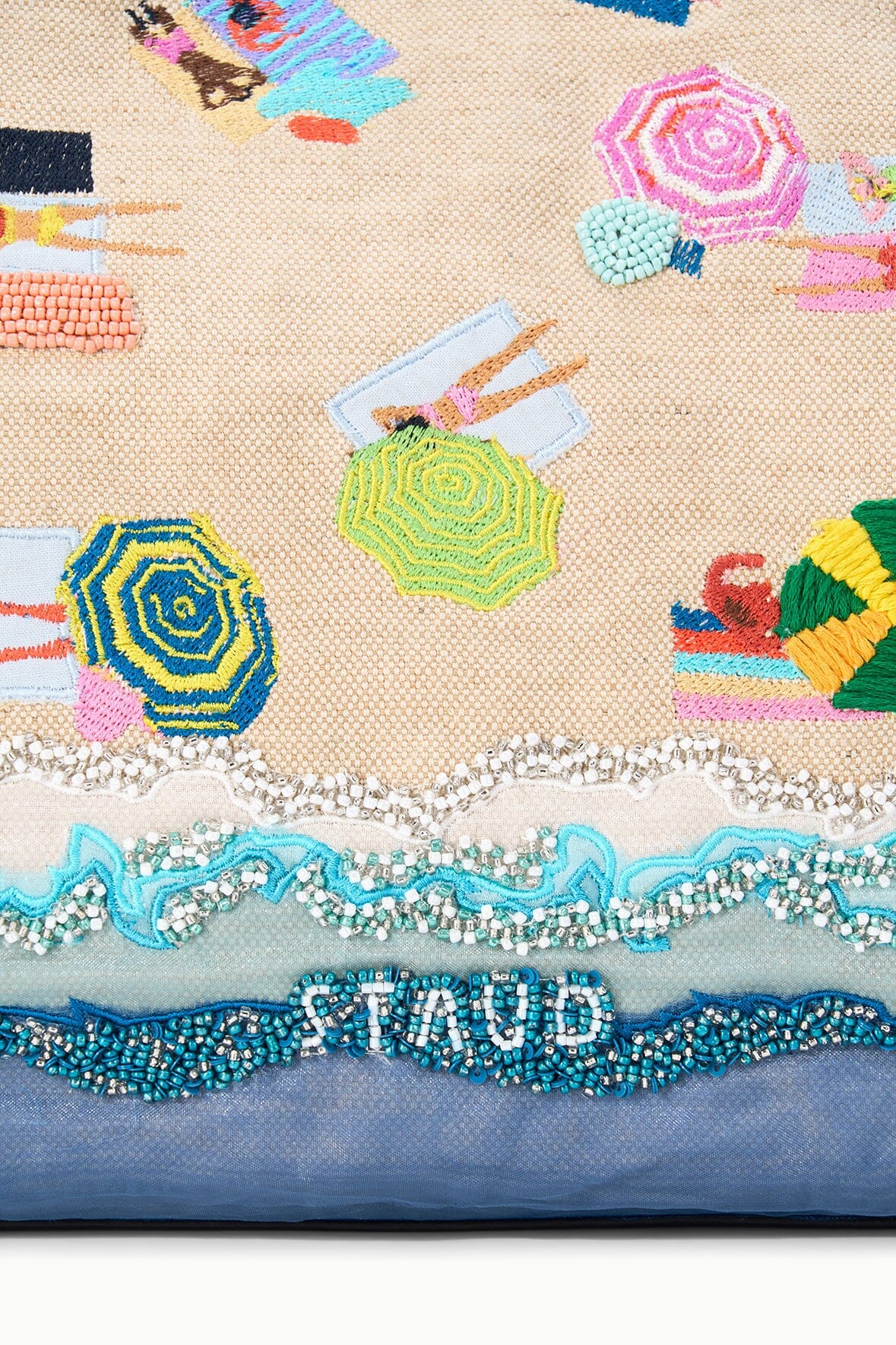 Close-up of beach tote bottom trim with bead accents and blue fabric panel