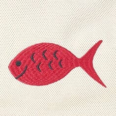 Close-up of red fish applique on cream canvas tote bag front