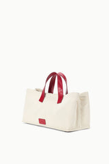 Cream canvas tote bag with red handles and centered fish applique on front