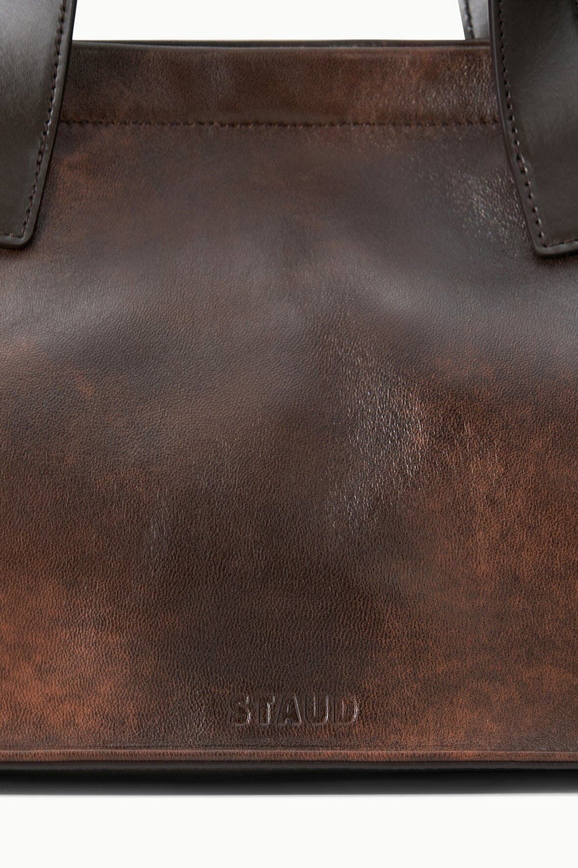 STAUD logo on espresso-brown distressed leather port tote front