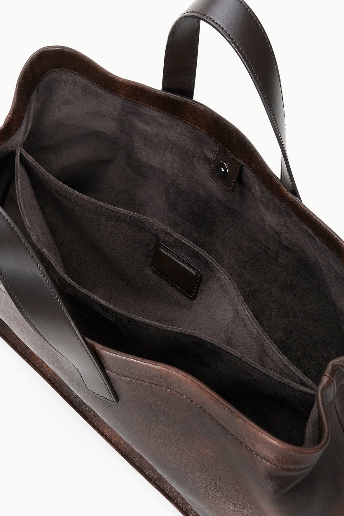 Espresso-brown distressed leather port tote interior with center pocket