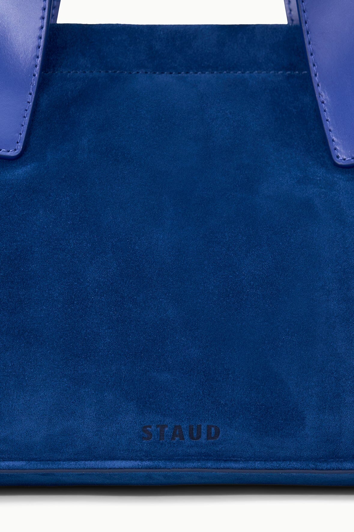 Cobalt blue port tote front with stitched seams and small STAUD logo patch