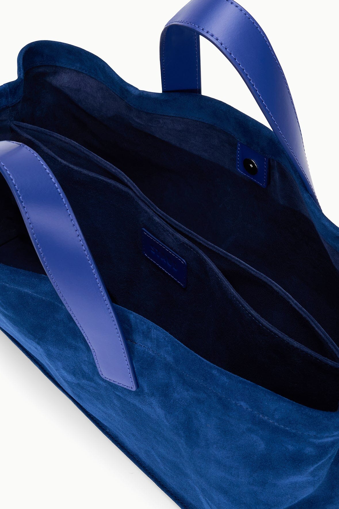 Cobalt blue port tote with leather-style handles, open top and interior pocket