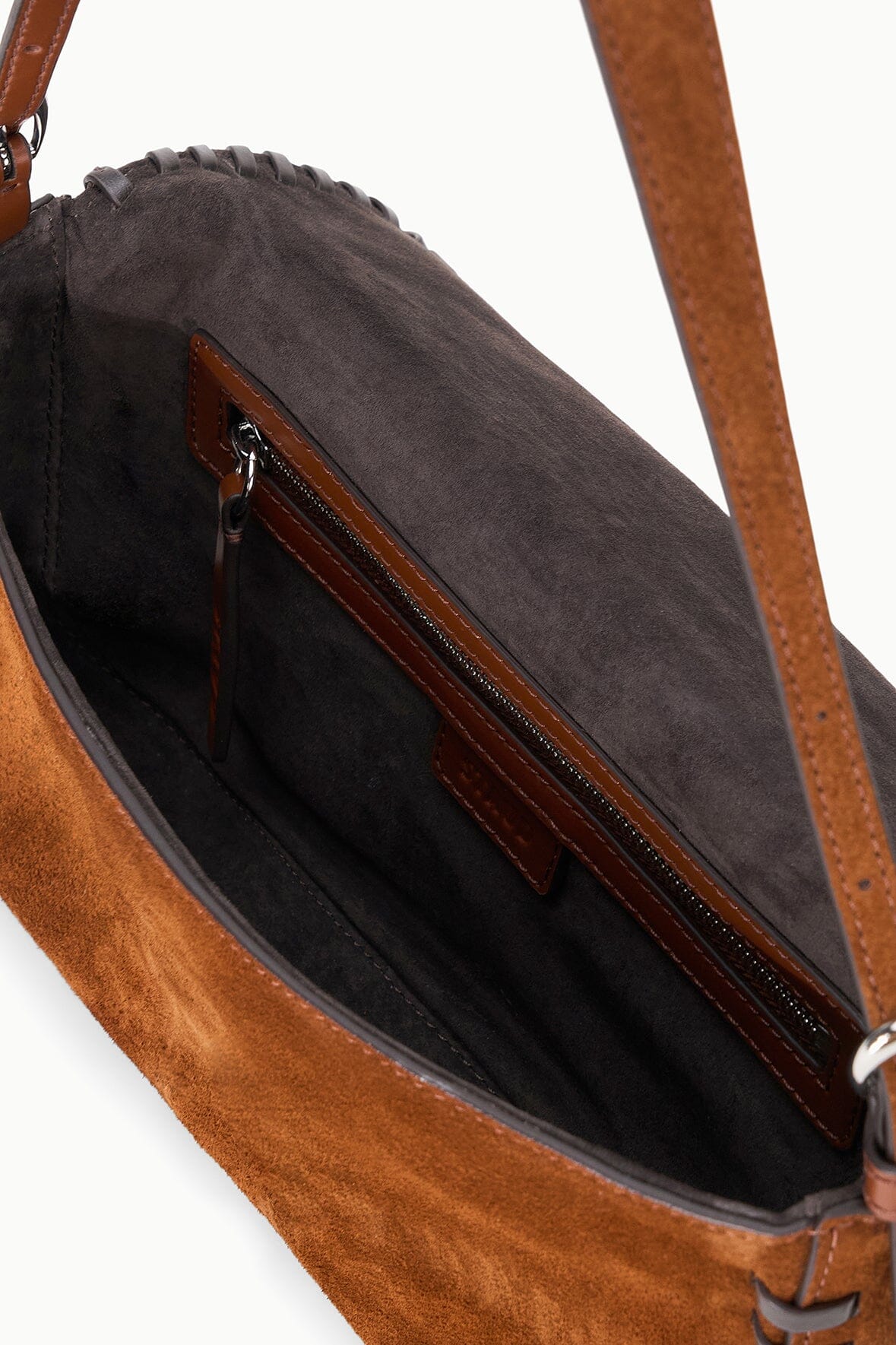 Suede bag interior view with zip pocket and leather top trim