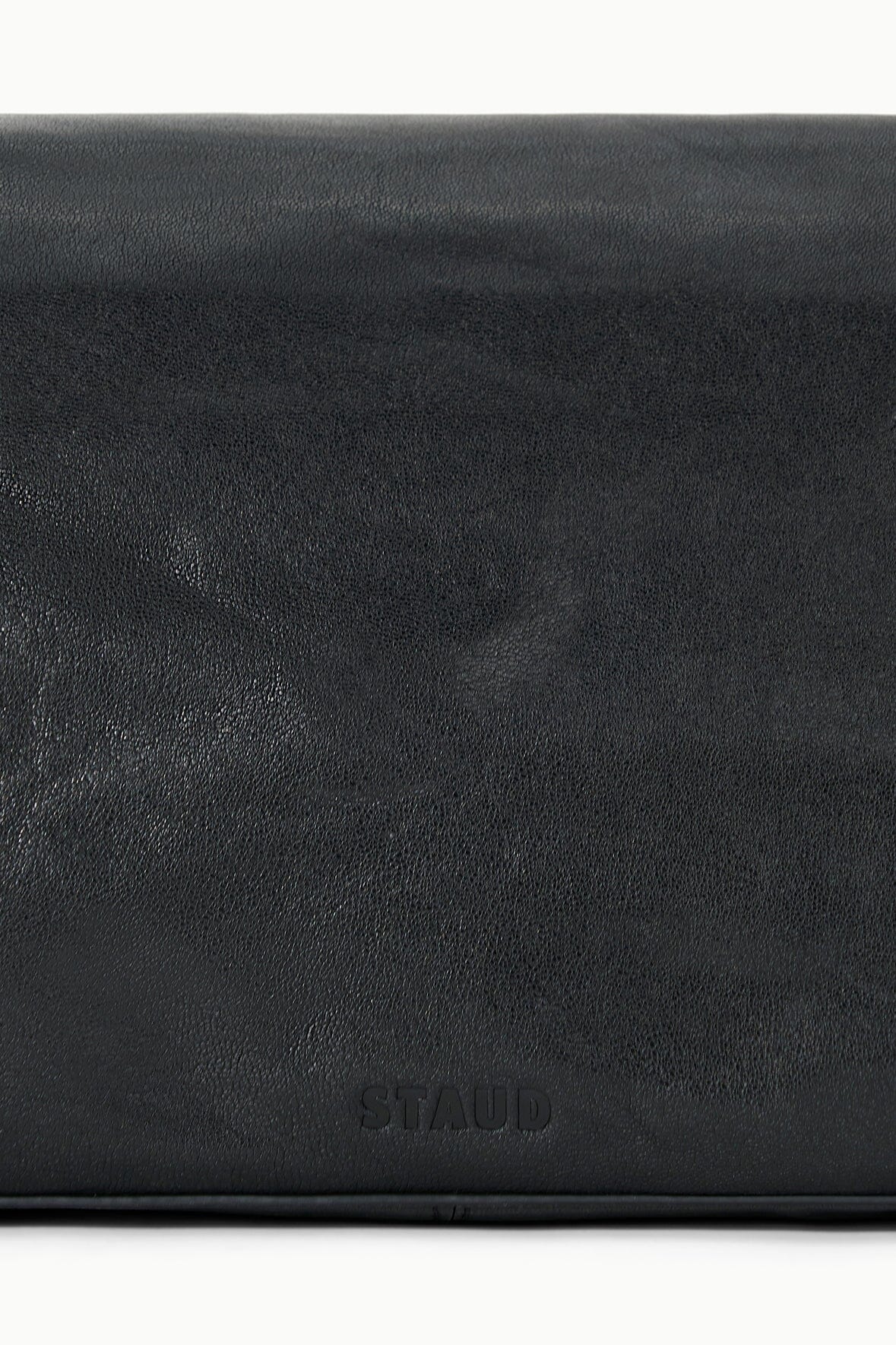 Black leather-look bag with “STAUD” embossed on the exterior panel