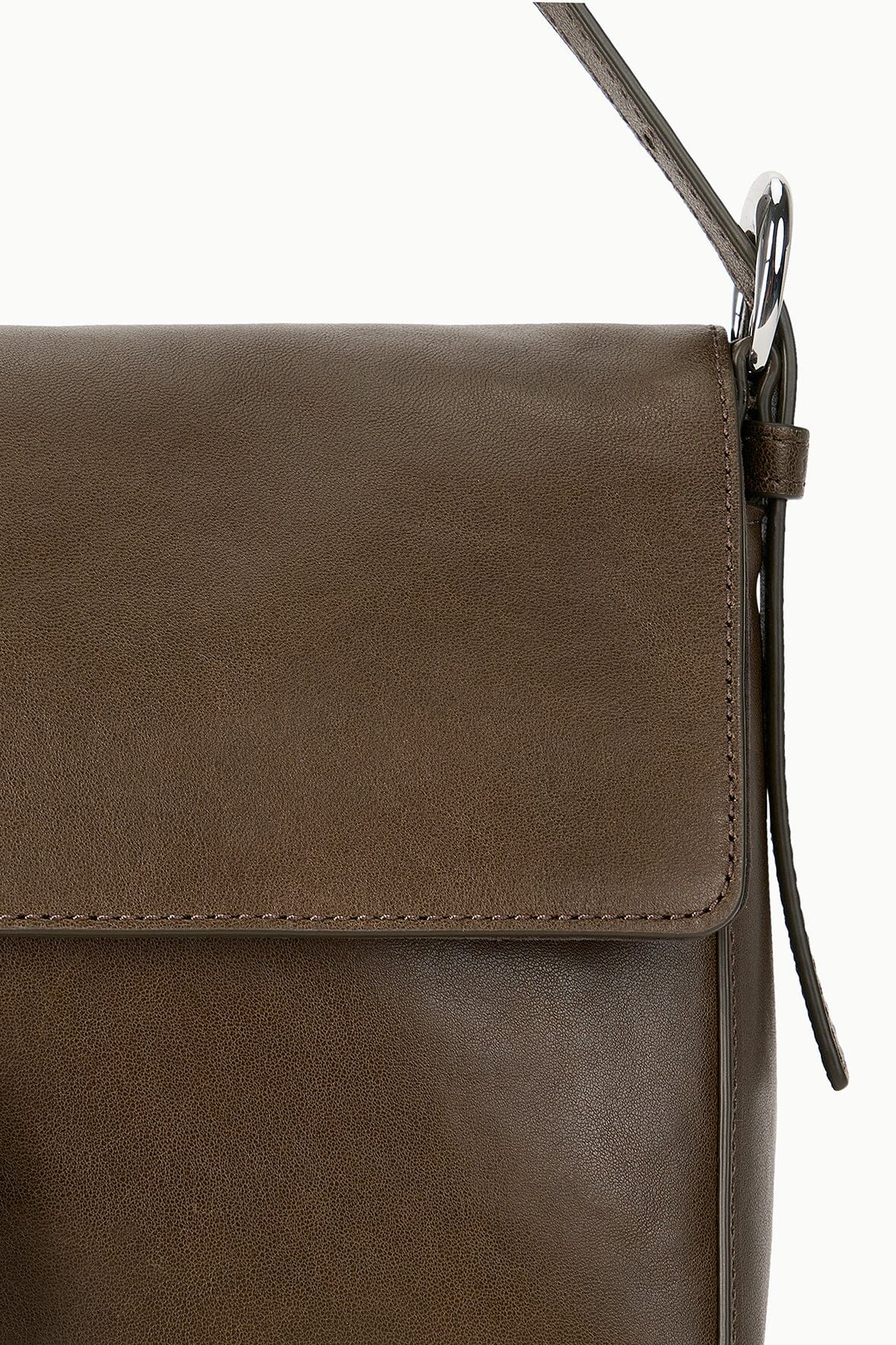 Truffle brown flap bag front detail with edge stitching and silver-tone clasp