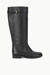 Black riding boot with pull-on shaft and buckle strap at top