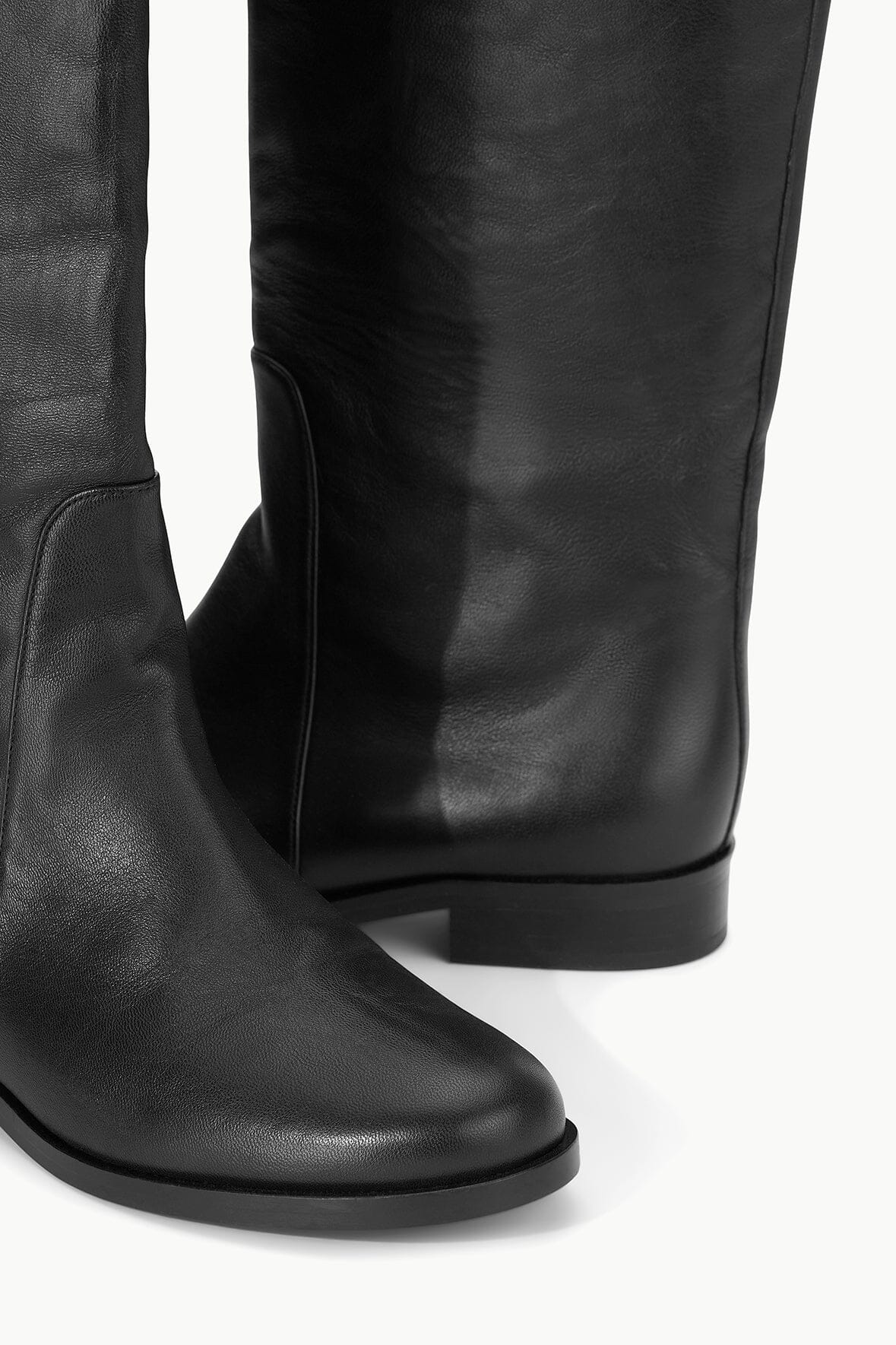 Black riding boot with seam detail near ankle and low heel